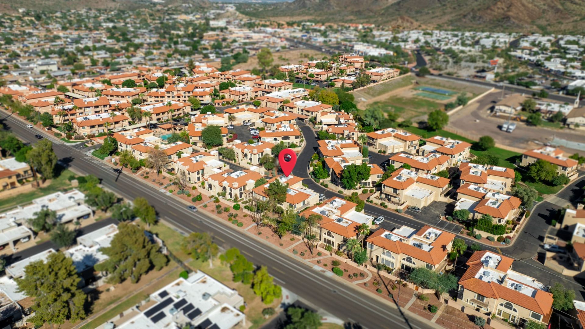 Wide aerial with the property pinned in the neighborhood