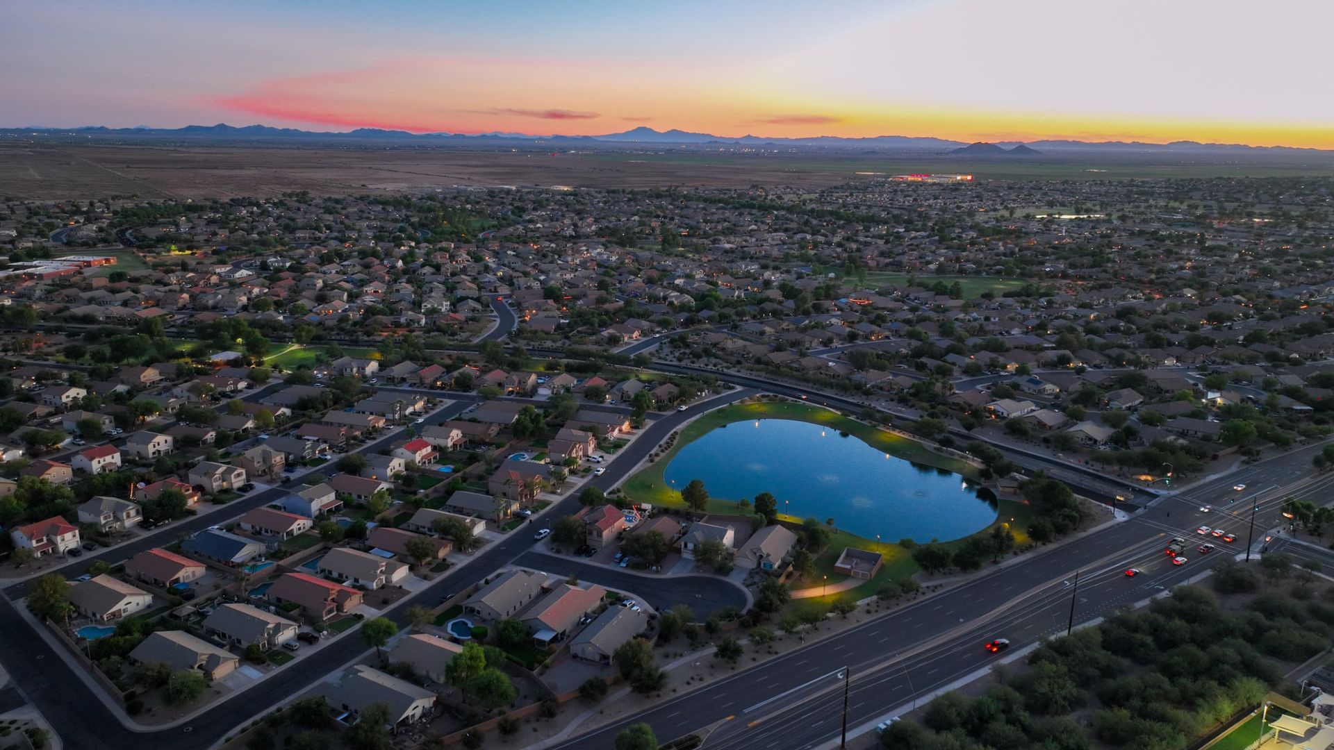 Sun Groves neighborhood and lake at sunset